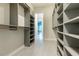 Spacious walk-in closet with custom shelving and view into bedroom at 2246 Fiesta Dr, Sarasota, FL 34231