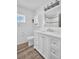 Bathroom vanity with modern white cabinets, a sink and a large mirror at 2514 Ohio S Ct, Gulfport, FL 33707