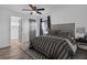 Primary bedroom features wood-look floors, ceiling fan, and neutral decor at 2514 Ohio S Ct, Gulfport, FL 33707