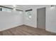 Cozy bedroom featuring wood-look floors, bright windows, and a clean, minimalist aesthetic at 2514 Ohio S Ct, Gulfport, FL 33707