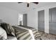 Comfortable bedroom with a stylish striped bedspread, wood-look flooring, and easy access to the kitchen at 2514 Ohio S Ct, Gulfport, FL 33707