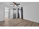 Bright bedroom features a ceiling fan, wood-look flooring, and neutral walls, offering a serene and modern feel at 2514 Ohio S Ct, Gulfport, FL 33707