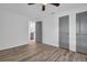 Inviting bedroom with wood-look flooring, neutral walls, and an open doorway leading to the kitchen at 2514 Ohio S Ct, Gulfport, FL 33707