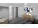 Stylishly furnished bedroom with wood-look floors, modern artwork, and a comfortable chair in the corner at 2514 Ohio S Ct, Gulfport, FL 33707