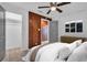 Stylish bedroom with wood accent wall, wood-look flooring, closet, and door to another room at 2514 Ohio S Ct, Gulfport, FL 33707