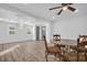 Bright dining area features modern ceiling fan, wood-look floors, and large windows at 2514 Ohio S Ct, Gulfport, FL 33707