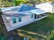 Single-story home showing backyard, screened-in porch, windows and door under an aging blue shingle roof at 2514 Ohio S Ct, Gulfport, FL 33707