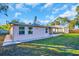 Rear exterior view of a single story home with screened in porch and manicured lawn at 2514 Ohio S Ct, Gulfport, FL 33707