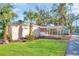 Charming single-story home featuring a covered area and vibrant green lawn at 2514 Ohio S Ct, Gulfport, FL 33707