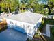 Aerial view of a detached garage with gray shingle roofing, a white exterior, and concrete driveway at 2514 Ohio S Ct, Gulfport, FL 33707