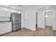 Spacious kitchen featuring stainless steel refrigerator, modern countertops and white cabinets at 2514 Ohio S Ct, Gulfport, FL 33707