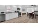Modern kitchen with stainless steel appliances, white cabinets, and wood-look floors at 2514 Ohio S Ct, Gulfport, FL 33707