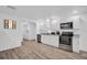 Modern kitchen with stainless steel appliances, white cabinets, and wood-look floors at 2514 Ohio S Ct, Gulfport, FL 33707