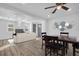 Well-lit living space with an open concept featuring vinyl floors, modern furniture and an elegant ceiling fan at 2514 Ohio S Ct, Gulfport, FL 33707