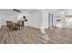 Sun-drenched living room featuring hardwood floors, ceiling fan and an open layout leading to a kitchen at 2514 Ohio S Ct, Gulfport, FL 33707
