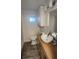 Small bathroom featuring a vessel sink, wood counter, and white cabinets at 27466 Us Highway 19 N # 97, Clearwater, FL 33761
