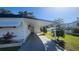 Carport showcasing the covered parking area, nice landscaping, and the home's exterior at 27466 Us Highway 19 N # 97, Clearwater, FL 33761