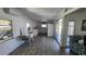 Bright dining area with light wood-look floors, an air conditioner, and open to the kitchen at 27466 Us Highway 19 N # 97, Clearwater, FL 33761