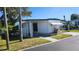 Charming mobile home featuring a covered carport and quaint landscaping at 27466 Us Highway 19 N # 97, Clearwater, FL 33761