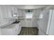 All-white kitchen featuring modern appliances and marble-look countertops at 27466 Us Highway 19 N # 97, Clearwater, FL 33761