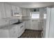 All-white kitchen featuring modern appliances and marble-look countertops at 27466 Us Highway 19 N # 97, Clearwater, FL 33761