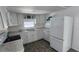 Bright kitchen with white cabinets, appliances and marble-look countertops at 27466 Us Highway 19 N # 97, Clearwater, FL 33761