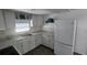 Well-lit kitchen with white cabinetry, appliances, and marble-look counters at 27466 Us Highway 19 N # 97, Clearwater, FL 33761