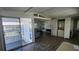 Bright living room featuring a sliding glass door and in-unit laundry at 27466 Us Highway 19 N # 97, Clearwater, FL 33761
