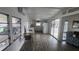 Open-concept living area with kitchen, dining space, and view of the screened porch at 27466 Us Highway 19 N # 97, Clearwater, FL 33761