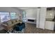Cozy living room featuring wood floors, a plush sofa, and convenient laundry appliances at 27466 Us Highway 19 N # 97, Clearwater, FL 33761