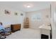 Cozy bedroom with neutral carpet, large windows, and vintage furniture at 3140 Carlos Dr, Dunedin, FL 34698