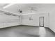 Spacious garage featuring clean, painted walls, ample lighting and ceiling fan at 3140 Carlos Dr, Dunedin, FL 34698