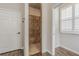 Bathroom featuring tiled shower with built-in seat, wood-look tile floor, and natural light at 3815 Gaviota Dr, Sun City Center, FL 33573