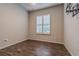 Bedroom with wood-look tile flooring, bright window, and ceiling fan at 3815 Gaviota Dr, Sun City Center, FL 33573