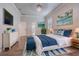 Bright bedroom with a comfortable bed, white dresser, blue accents, and coastal decor at 3815 Gaviota Dr, Sun City Center, FL 33573