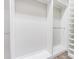 Walk-in closet featuring custom shelving, hanging rods and ample storage space at 3815 Gaviota Dr, Sun City Center, FL 33573