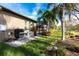 Well-maintained backyard with tropical landscaping and mature trees at 3815 Gaviota Dr, Wimauma, FL 33598