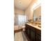 Bathroom with granite counters, tiled shower and decorative mosaic mirror at 3815 Gaviota Dr, Sun City Center, FL 33573