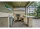 Outdoor kitchen area featuring granite counters and stone accents at 3815 Gaviota Dr, Wimauma, FL 33598