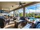 Covered outdoor living area featuring comfortable seating, an outdoor kitchen, and a view of the pool at 3815 Gaviota Dr, Wimauma, FL 33598