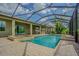 Relaxing screened-in pool and spa with outdoor kitchen and large patio at 3815 Gaviota Dr, Wimauma, FL 33598