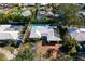 Aerial view of a well-maintained home with a pool, tiki bar, and lush landscaping in a serene neighborhood at 4000 40Th S St, St Petersburg, FL 33711