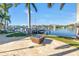 Waterfront backyard with fire pit and boat dock offers picturesque views of the water at 751 34Th Ne Ave, St Petersburg, FL 33704
