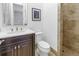 Bathroom featuring a modern vanity with a vessel sink, a round mirror, and a glass-enclosed shower at 751 34Th Ne Ave, St Petersburg, FL 33704