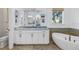 Bathroom featuring a soaking tub, double vanity and a window with a view at 751 34Th Ne Ave, St Petersburg, FL 33704