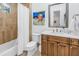 Traditional bathroom with wood vanity, white countertop, bathtub, and shower with neutral tile at 751 34Th Ne Ave, St Petersburg, FL 33704