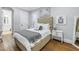 Cozy bedroom with tufted headboard, wood floors and ensuite bath at 751 34Th Ne Ave, St Petersburg, FL 33704