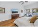 Bright bedroom featuring wood floors, a mounted television, water views and comfortable furnishings at 751 34Th Ne Ave, St Petersburg, FL 33704