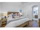 Bright bedroom featuring hardwood floors, neutral walls, and a comfortable bed with decorative pillows at 751 34Th Ne Ave, St Petersburg, FL 33704