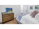 Cozy bedroom with wood floors, a bamboo dresser and beach themed art on the white walls at 751 34Th Ne Ave, St Petersburg, FL 33704